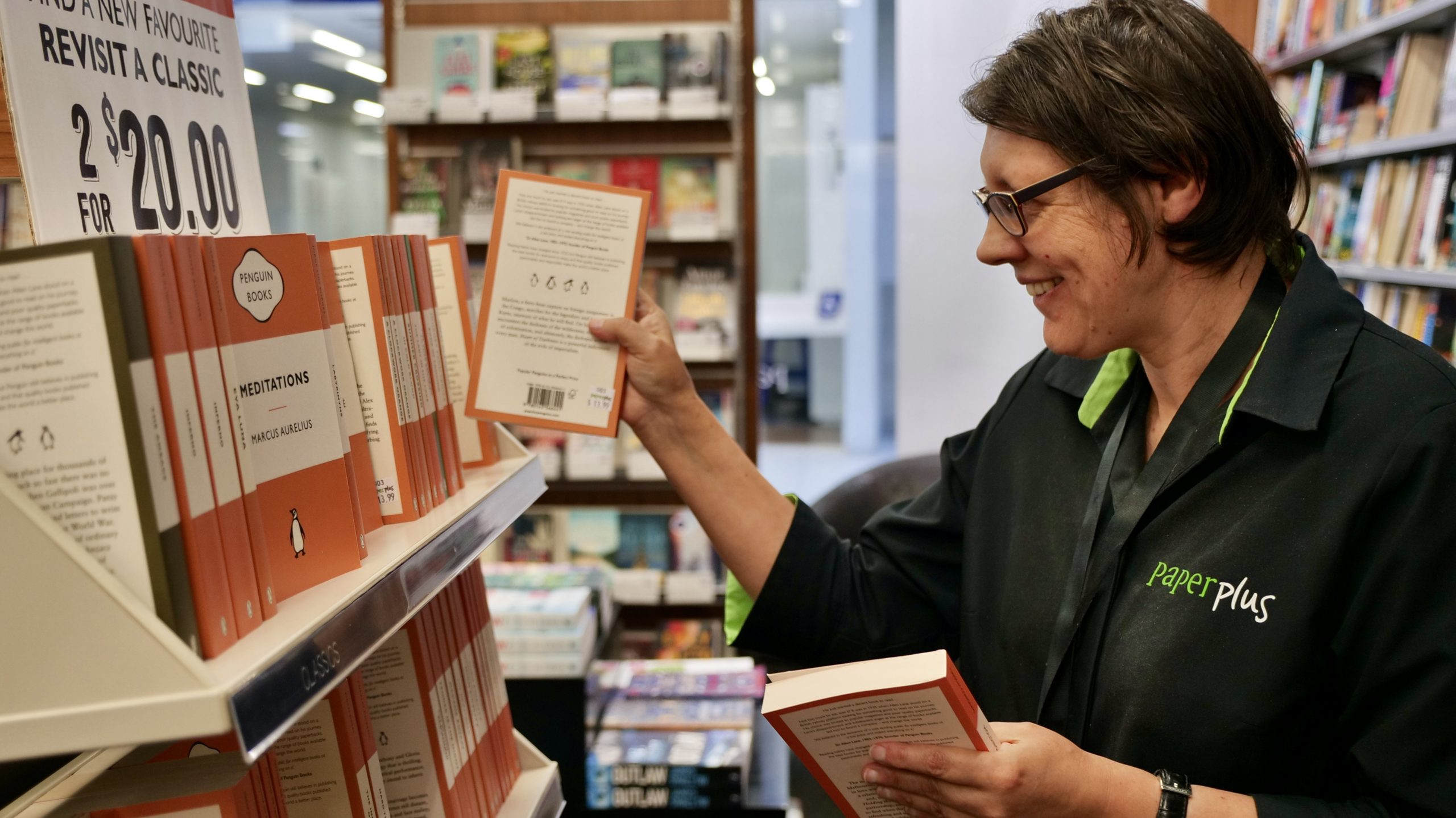 Rachel stocking the shelves at Paper Plus