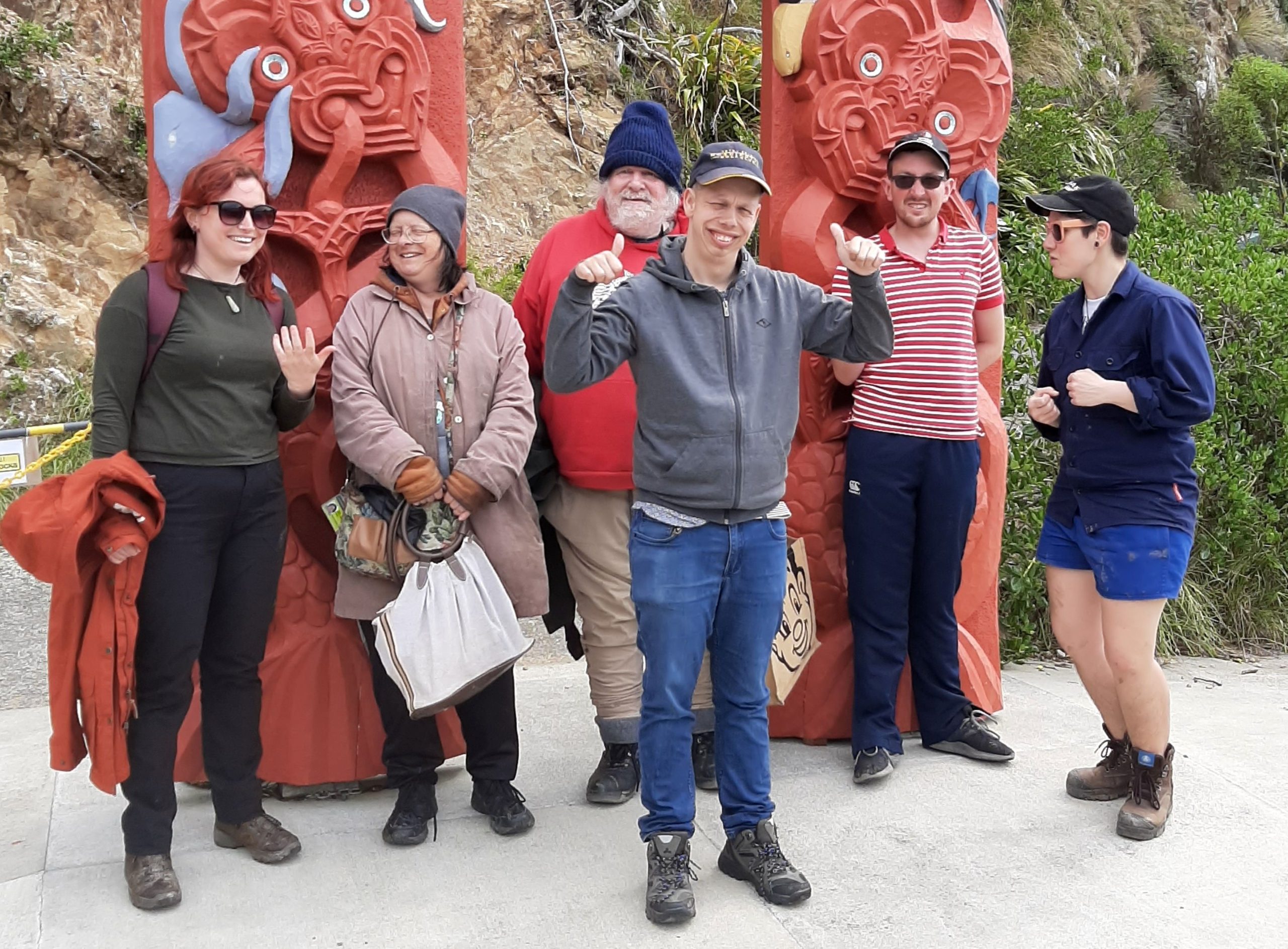 Dom – matiu Island Group of people by carved images on Matiu Island